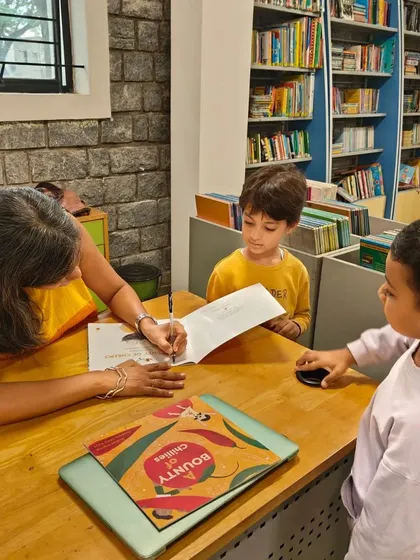 A duplicate image showing the book signing moment, highlighting the personal interaction.