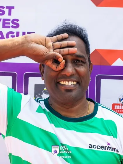 A participant poses for the camera with a smile, capturing the fun and relaxed atmosphere of the Just Fives League. It's a day for teams to unwind and connect.