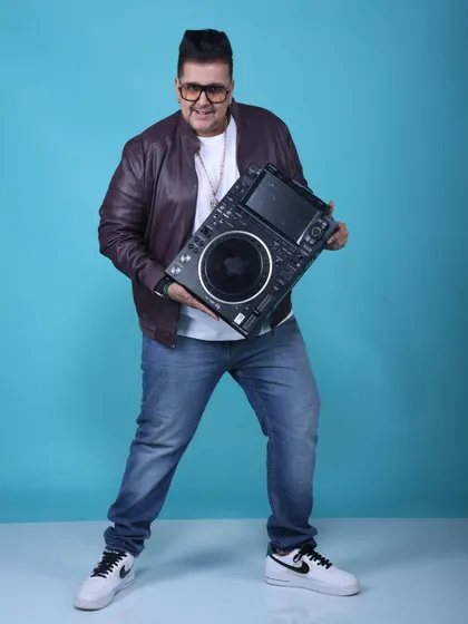 Holding up the tool of my trade, a Pioneer CDJ. This is where the magic is made. My equipment is top-of-the-line to ensure a flawless musical experience.