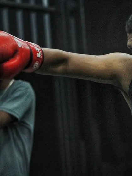 Don't be scared of getting punched; it's part of the game. Here, a boxer practices landing a clean jab while keeping his guard up.