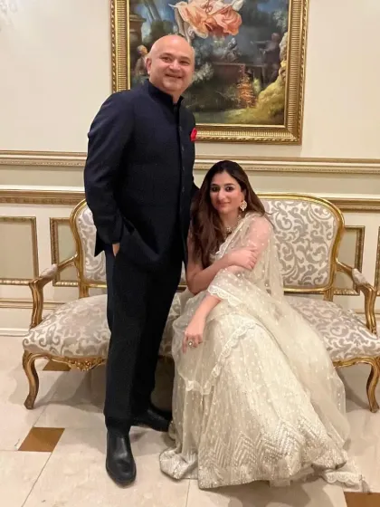 A suit that speaks for itself. My client, pictured with his wife, wears a custom navy bandhgala, crafted with precision for a look of timeless elegance.