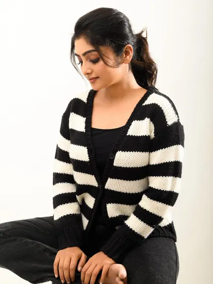 A slightly different angle, capturing a thoughtful expression. The black and white stripes create a nice graphic element.