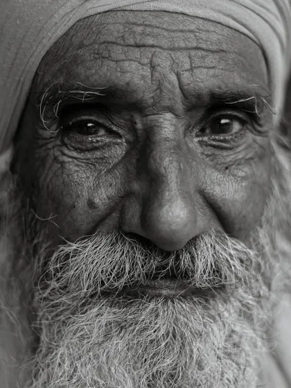 The lines on a person's face tell a lifetime of stories. This intense, close-up black and white portrait was taken to emphasize the texture of his skin and the wisdom in his eyes, proving that the most powerful instrument a photographer has is his own vision.