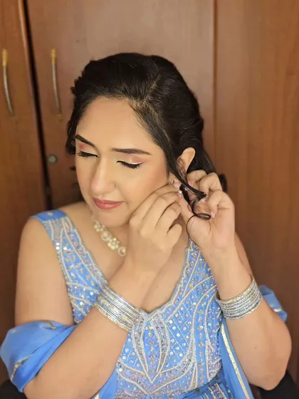 Anishaa adding the final touch with her earrings, looking absolutely ready for her engagement party.