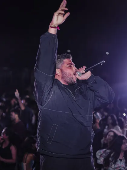On the mic, commanding the stage at NIFT Mumbai. I use my voice to hype the crowd and guide the party's energy.
