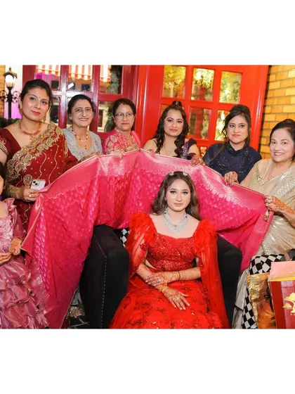 A traditional moment with the bride surrounded by the women in her family.
