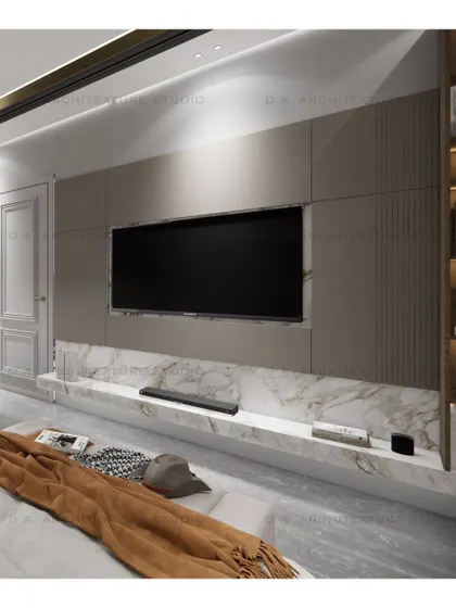 The TV wall in the Vishal Enclave bedroom, featuring a floating marble-topped console and built-in shelving for a clean, organized look.