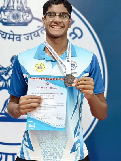 Akash Mani with his bronze medal in the 100m Men's Backstroke.
