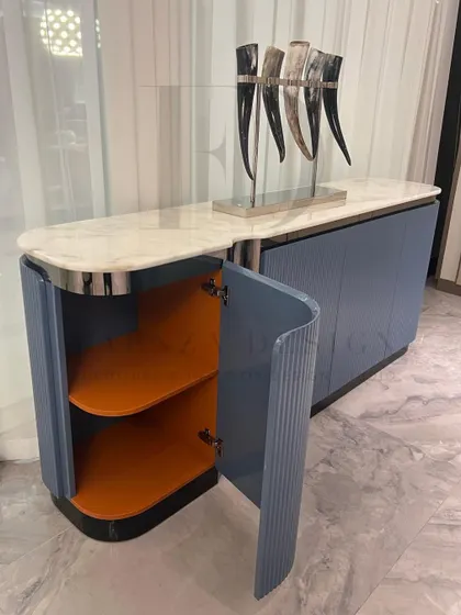 A look inside the custom blue-grey console, revealing the unexpected and luxurious orange leather-lined interior. This hidden detail is a signature of our thoughtful design process.