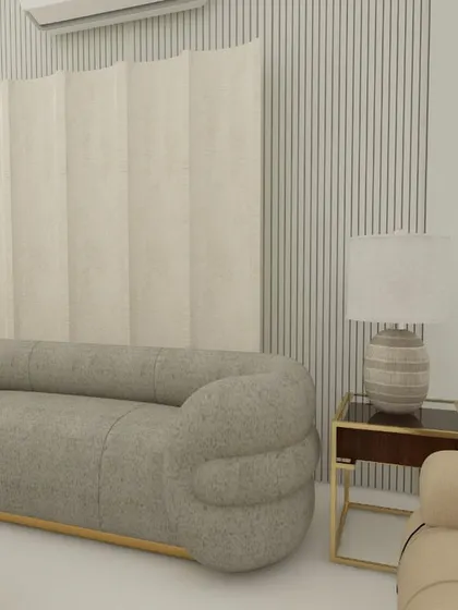 A close-up of the unique, rounded grey sofa and the combination of fluted and fabric wall panels. This design is all about soft curves and interesting textures.