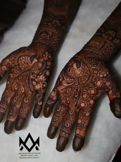 A detailed peacock design on the palms, a classic and auspicious motif in Indian bridal mehendi.