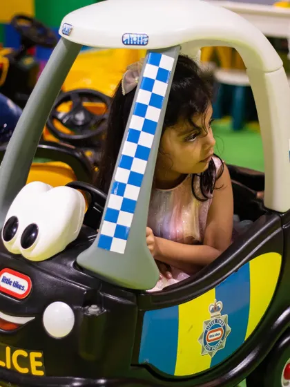 This little police officer is ready to keep the peace in her friendly police car ride-on.