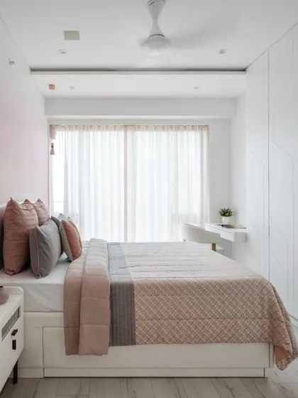 A wider view of the pink ombré bedroom, showing the full effect of the gradient wall, the sleek study nook, and the light, airy feel of the space.