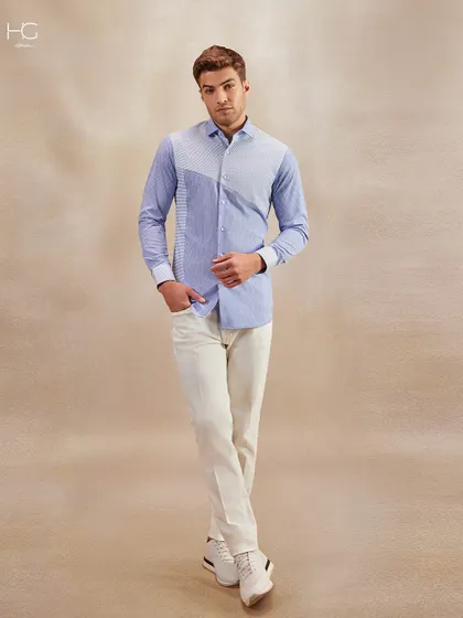 This striped panel shirt is shown in a full-length view, paired with white trousers and sneakers for a smart casual look that is perfect for any setting.