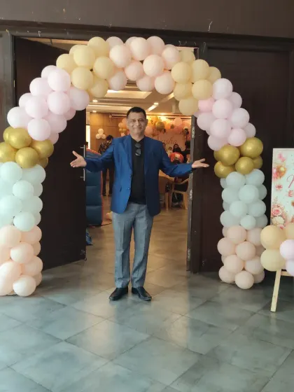 Welcoming guests at the entrance of a beautifully decorated party hall. My job starts the moment guests walk in, making them feel excited for the event ahead.