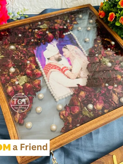 This shot shows the beautiful details of the preserved flowers and the pearl-bordered photo within the teakwood frame.
