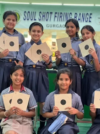 A class of students from K.R. Mangalam World School after a successful shooting session. Team activities help build camaraderie and sportsmanship.
