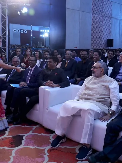 Interacting with guests in the front row at the Export Awards. Even in a formal setting, I make sure to connect personally with the attendees.