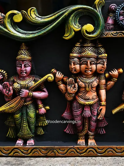 This detail from the Meenakshi panel highlights the four-headed Lord Brahma and Goddess Saraswati, rendered in vibrant, contrasting colors.