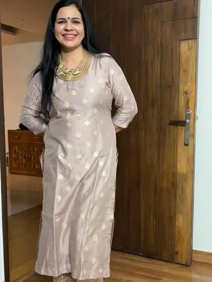 This light pink suit with gold embroidery is a very elegant and understated piece. It's perfect for those who prefer softer colors for festive wear.