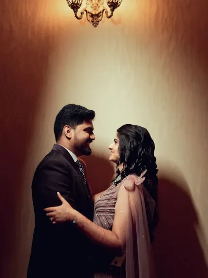 A classic romantic pose from an engagement or reception, showcasing the couple's connection and elegant attire.
