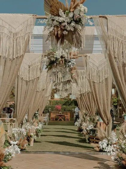 The entrance to the welcome lunch, draped in macrame and jute, perfectly capturing the earthy, Tulum-inspired aesthetic.