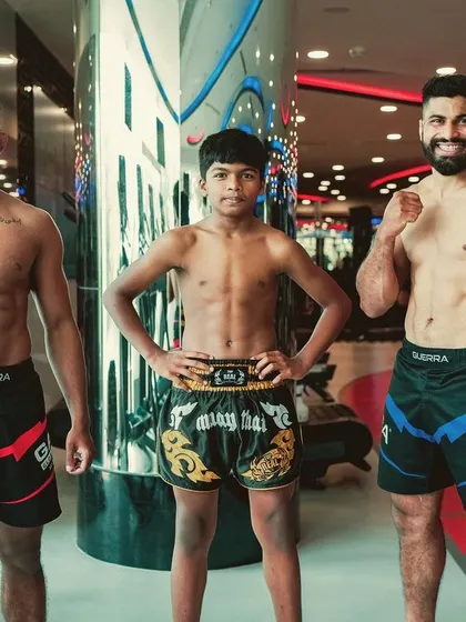 The next generation of fighters. Two of our seasoned athletes posing with a younger member, all displaying the results of their hard work and dedication.