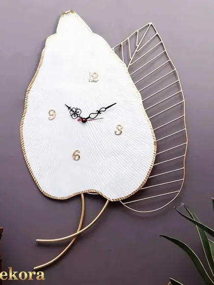 This large, single-leaf wall clock in white and gold is a statement of minimalist elegance, perfect for a serene bedroom or living area.