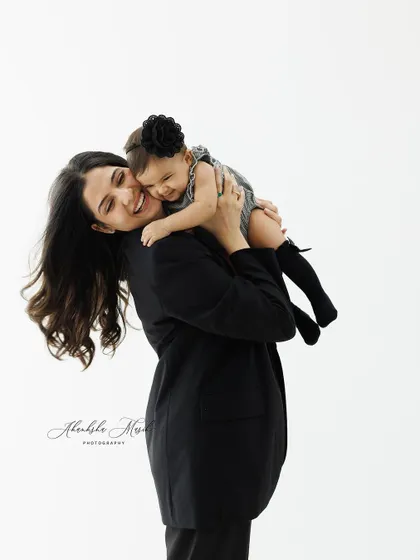 A joyful hug between a mother and her baby girl. The pure happiness on both their faces makes this an incredibly heartwarming portrait.