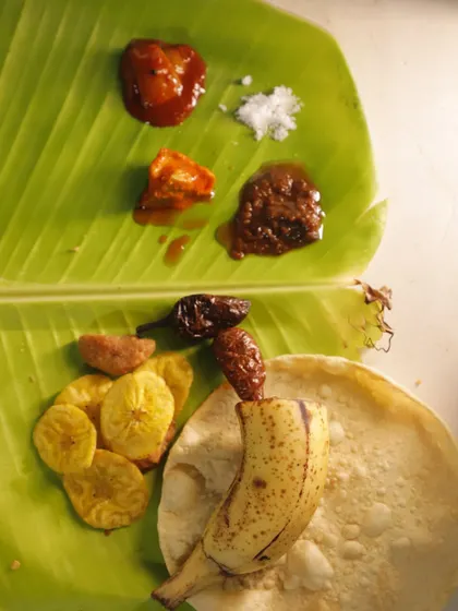 The meal begins with these flavor starters. Tangy pickles, spicy chutneys, salt, banana chips, and a ripe banana awaken the palate and prepare you for the feast to come. The crispy papadum adds a satisfying crunch.