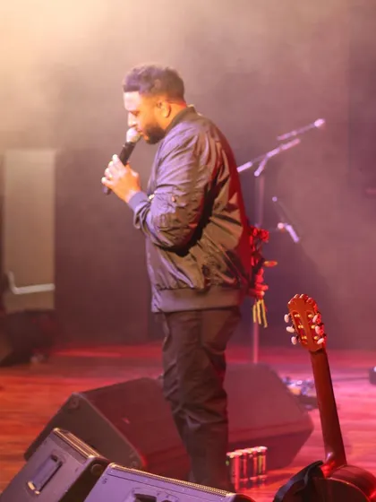 Ash King mid-performance, with the stage lighting creating a dramatic effect.