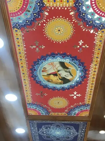 A single, finished Lippan art panel with a Radha-Krishna centerpiece, installed on a showroom ceiling. The combination of painting, clay work, and mirrors creates a multi-dimensional piece of art.