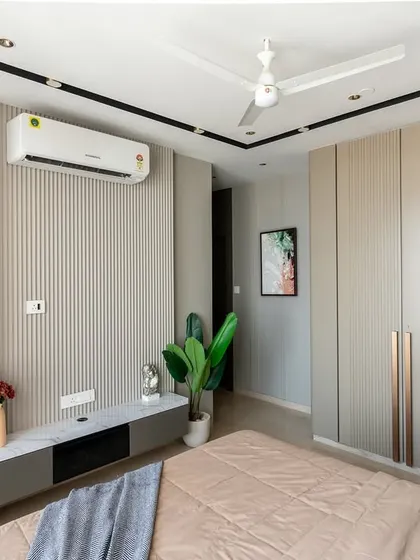 A bedroom that redefines quiet luxury. Vertical louvers create a textured rhythm, the curved open shelving cabinet softens the space, and the high-gloss PU finish wardrobe reflects contemporary style.