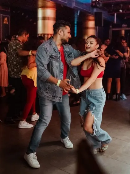 A fun, playful moment during a social dance. It's all about having a good time and sharing that happy energy.