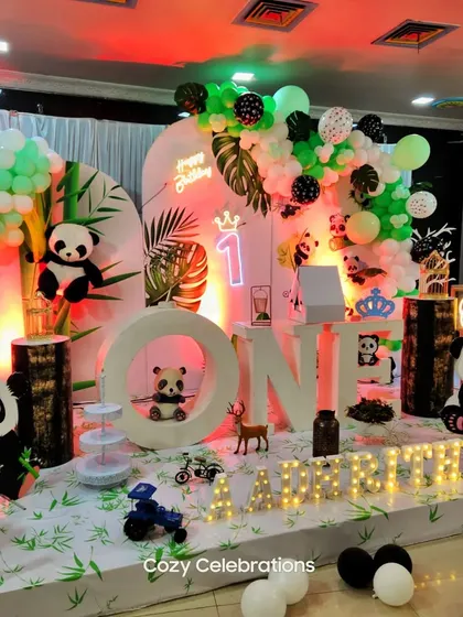 A cute panda-themed first birthday with bamboo-style props and a greenery backdrop.