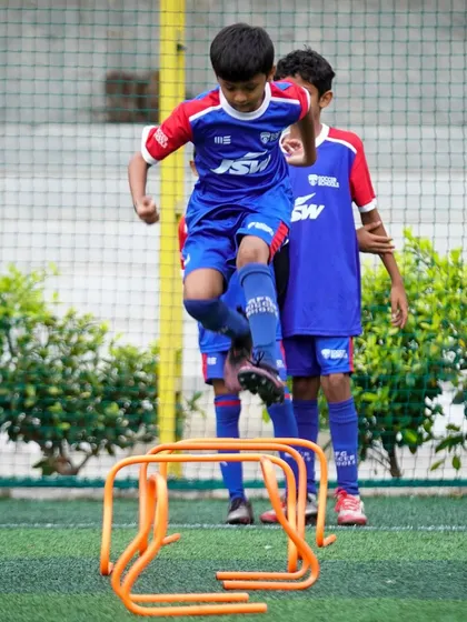 A young player clears hurdles during an agility drill. We focus on developing the speed, coordination, and power essential for a modern footballer.