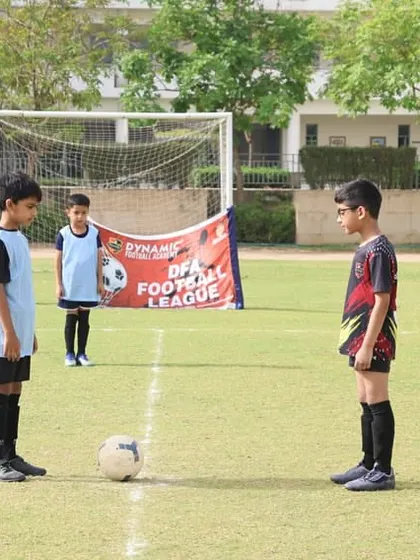 Two players face off at the center line for the kick-off of a league match.
