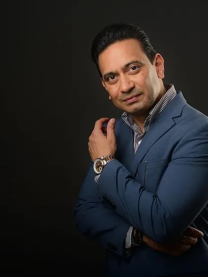 A stylish corporate portrait with a three-quarter turn. This pose is flattering and adds a dynamic feel to a standard professional headshot.
