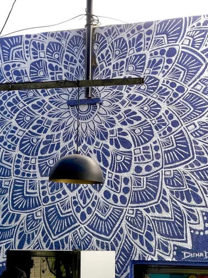 This 9x7 foot blue and white mandala mural was created for a cafe, becoming an instant photo backdrop for customers. It completely transformed the look and feel of the space.