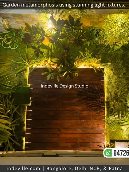 A wooden gate surrounded by a lush vertical garden and dramatic uplighting. This creates a mysterious and enchanting entrance to the garden at night.