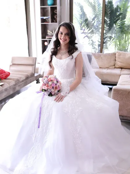 A full-length view of Crystal's stunning bridal look. The ball gown, the veil, and the timeless hair and makeup create a picture of pure elegance.