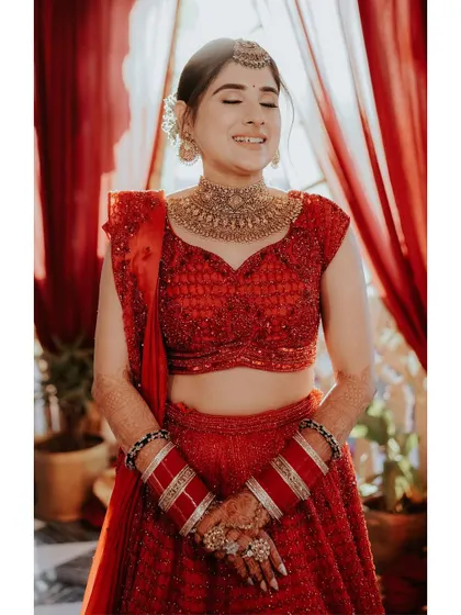 The bride's joyful, eyes-closed smile, a moment of pure happiness and contentment captured in a beautiful, warm light.