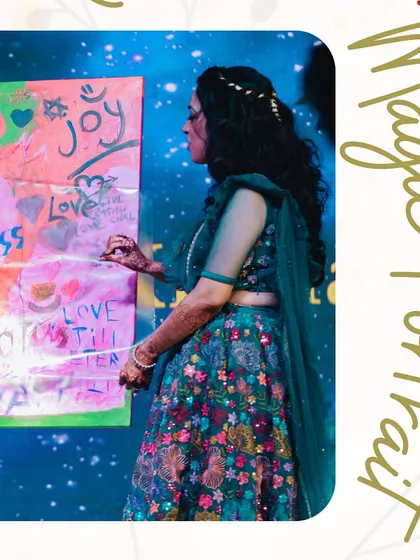 The bride adds her creative touch to the 'Magic Portrait' canvas before the big reveal. This activity is a beautiful, artistic symbol of the couple creating their new life together.