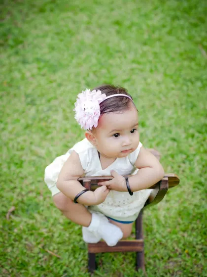 A simple and sweet outdoor portrait. The lush green grass provides a perfect, natural backdrop for this little girl in her white dress.