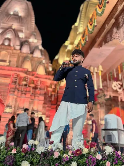 Standing on a stage adorned with flowers, with the grand temple setup behind me. A truly divine setting.