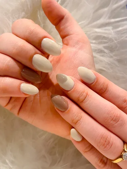 Another angle of this chic, coffee-inspired manicure. The almond-shaped nails are painted in coordinating neutral shades for a sophisticated and modern look.