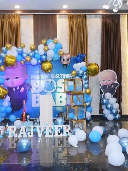 Another view of the impressive Boss Baby themed stage. The use of blue, white, and gold balloons creates a sophisticated yet fun look for a first birthday.