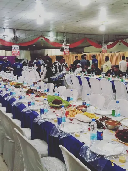 A large-scale Dastarkhwan setup for a men's gathering. The blue and white theme with long, continuous tables creates a striking visual for any grand event.