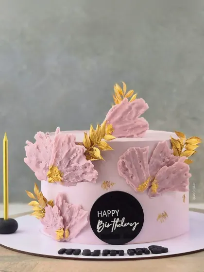 A lovely pink cake with abstract, textured petals and gold leaf accents, perfect for a mother's birthday or Mother's Day.