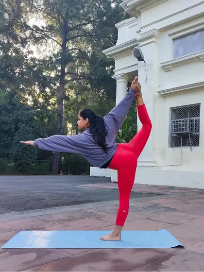 A classic Natarajasana (Lord of the Dance Pose) with a deep backbend. This pose builds balance and concentration while opening the shoulders and chest.